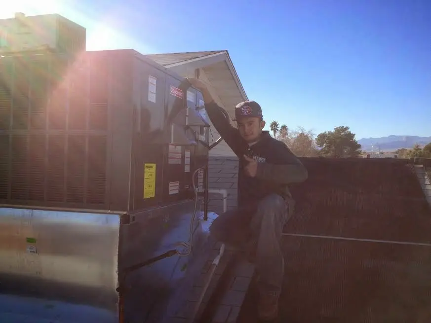 HVAC technician performing HVAC Inspection on a rooftop unit in South Hill